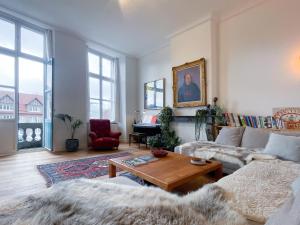 a living room with a couch and a table at Appartement spacieux & calme avec vue sur l'Escaut in Tournai