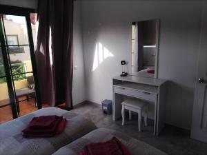 a bedroom with a bed and a vanity with a mirror at Premium Duplex Castillo Mar 32 in Caleta De Fuste