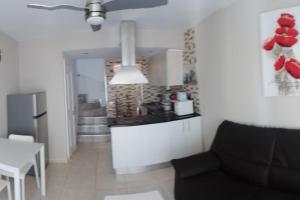 a living room with a couch and a kitchen at Premium Duplex Castillo Mar 32 in Caleta De Fuste