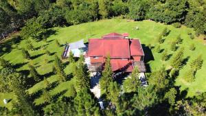 an aerial view of a large house with a red roof at Villa Bartolo By Hospedify - Lujo y mejor vista de Jarabacoa Piscina Billar Rio in Jarabacoa