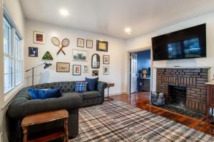 a living room with a couch and a fireplace at Pruett Place Downtown Home in Knoxville