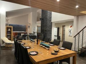 a large wooden table in a living room with chairs at Appartement spacieux près des pistes in Le Monêtier-les-Bains