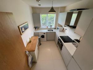 a small kitchen with a sink and a stove at 2 Bed 2 Bathroom Gated Apartment 1 Inc free Parking in Bromley