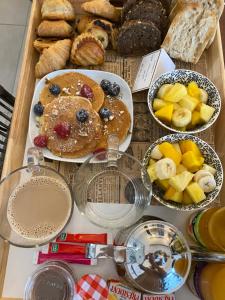 una mesa cubierta con platos de productos para el desayuno y bollería en O Bain Soleil, en Bourg-Saint-Andéol