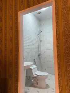 a bathroom with a toilet and a sink at Almazham hotel room resort in AlUla