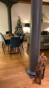 a living room with a christmas tree and a table at ROYAL WILLIAM YARD Luxury Apartments at "THE BRUCE" - FAMILY APARTMENT and Connecting DELUXE STUDIO - PRIVATE connecting lobby so BOOK BOTH For LARGER GROUPS - FREE ONSITE PARKING in Plymouth +37 photos