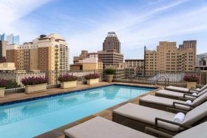 a swimming pool on top of a building with a city skyline at Mokara Hotel & Spa in San Antonio
