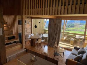 a living room with a couch and a table with chairs at Olladas de Barbeitos in Fonsagrada