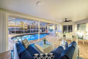 a living room with a blue couch and a pool at 430 Driftwood Court in Marco Island