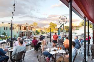 a group of people sitting at tables on a patio at Elegant Colonial with Lovely Details and Character in Memphis
