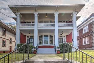 a house with a porch with columns at Classic Woodwork and Details in 1912 Colonial in Memphis