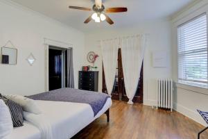 a bedroom with a bed and a ceiling fan at 1900s Historic Getaway in Memphis