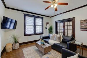 a living room with a couch and a ceiling fan at 1900's Historic Getaway - Prime Midtown Location! in Memphis