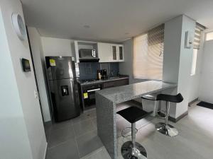 a kitchen with a counter and a refrigerator at Edificio apartamentos central con ascensor 502 in Bogotá