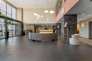 an office lobby with a reception desk and chairs at Best Western Plus Airport Inn & Suites in Saskatoon