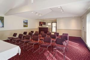a room with chairs and a table and a podium at SureStay Hotel by Best Western North Vancouver Capilano in North Vancouver +20 photos