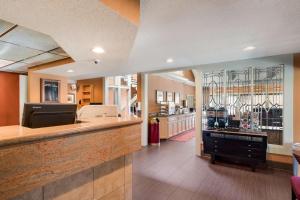 a large room with a bar and a kitchen at SenS Suites Livermore; SureStay Collection by Best Western in Livermore