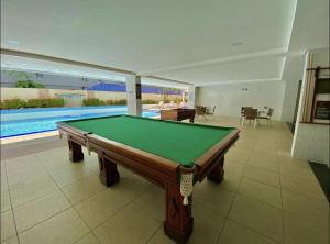 una mesa de billar en una habitación con piscina en Flat beira mar Tambaú, en João Pessoa