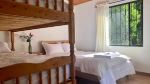 a bedroom with two bunk beds and a window at Corazón de la Montaña in Tibasosa