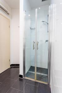 a shower with a glass door in a bathroom at Studio apartment Negi in Split