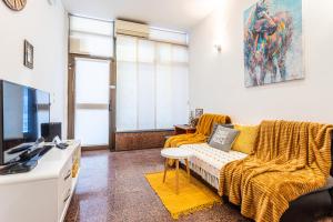 a living room with a couch and a tv at Studio apartment Negi in Split