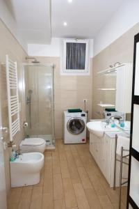 a bathroom with a toilet sink and a washing machine at Rucellai Guest House in Milan +28 photos
