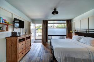 a bedroom with a bed and a flat screen tv at The Montauk Beach House in Montauk +91 photos