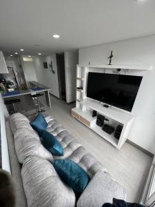 a living room with a couch with blue pillows at Edificios de apartamentos central con ascensor 604 in Bogotá