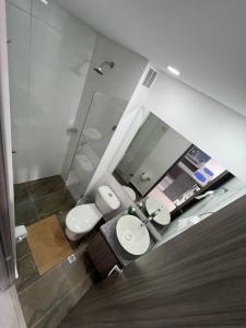 a bathroom with two toilets and a mirror at Edificios de apartamentos central con ascensor 604 in Bogotá