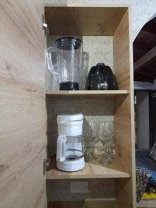 a cupboard with a blender and other items on it at Amoblado centro de la Moda in Itagüí