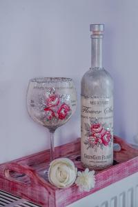 a bottle of wine and a wine glass on a shelf at Dimitropoulos Seafront Apartments-Elaionas Beach near Diakopto in Eleonas