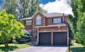 a brick house with a basketball hoop at Cheerful 7 bedrooms Villa with Hot tub & Pool. in Mississauga
