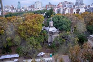 un edificio en un parque con una ciudad al fondo en Las Heras 2700 - Luxury 3 Bd Palermo Chico en Buenos Aires