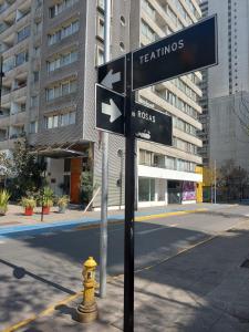 a street sign next to a yellow fire hydrant at Departamentos Amoblados R&M in Santiago