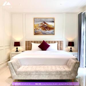 a bedroom with a large white bed and a couch at Khách sạn LAVENDER - Vincom Tây Ninh in Tây Ninh