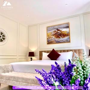 a bedroom with a bed and purple flowers at Khách sạn LAVENDER - Vincom Tây Ninh in Tây Ninh