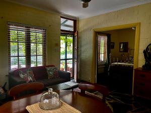 a living room with a couch and a table at Battunga Cottages in Watervale