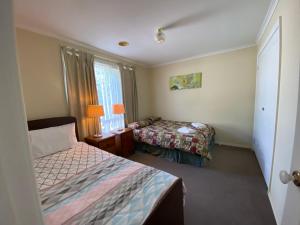 a hotel room with two beds and a window at 4 Beds-Whole House-U2-9 Dennis Street-Reservoir in Melbourne