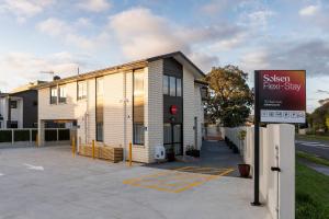 a sign in front of a building at Solsen Flexi-Stay & Motel in Auckland