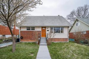 a house with a orange door and a brick wall at Lovely 2 Bedroom, 2 Bath Unit in West Alexandria. in Alexandria