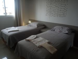 dos camas sentadas una al lado de la otra en una habitación en Aconchegante apartamento em Itapema 300 mts praia, en Itapema