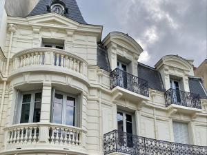 a large white building with balconies on top of it at Appartement Vichy, 2 pièces, 2 personnes - FR-1-489-364 in Vichy