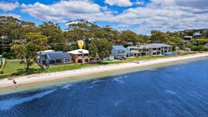 una vista aérea de una playa con casas y agua en Footprints on Foreshore, en Salamander Bay