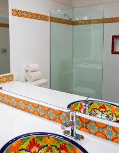 a bathroom with a sink and a shower at Las Rocas Resort & Spa in Rosarito