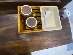 a tray with two cups and a spoon on a table at Manjari Villas Madiha in Matara