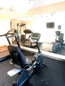 a gym with two exercise bikes and a mirror at Baymont by Wyndham Lynchburg in Lynchburg
