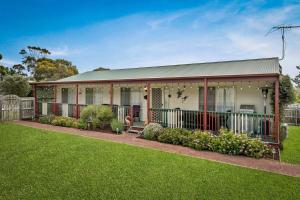 a house with a fence and a yard at Cross Rhodes in Wimbledon Heights