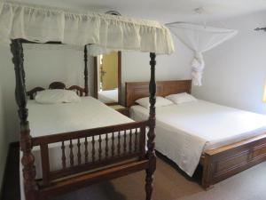 two beds in a room with two bedsskirts at No.53 in Katunayaka