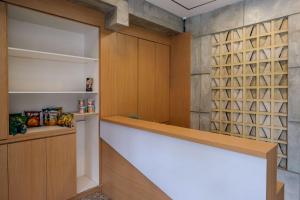 a walk in pantry with a wall of wine bottles at Urbanview Hotel Syariah Artamara Tegal by RedDoorz in Tegal