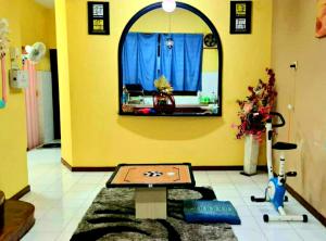 a room with a table in the middle of a room at D'Serina Homestay-3 bedroom 6 bed & free parking in Sungai Petani